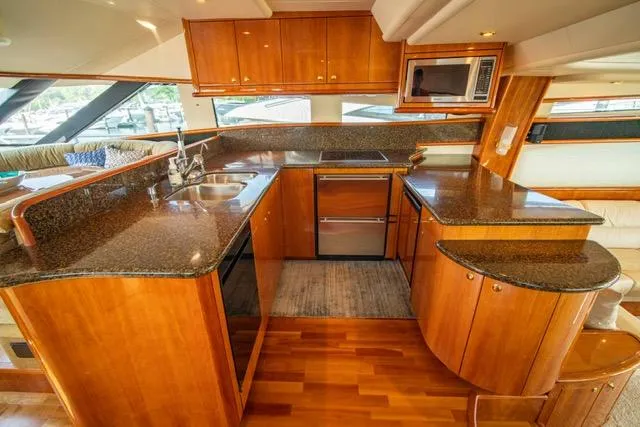 Slide: The Image of Luxurious kitchen in 2005 Neptunus 62 Flybridge yacht with wood cabinetry and granite countertops. - 3