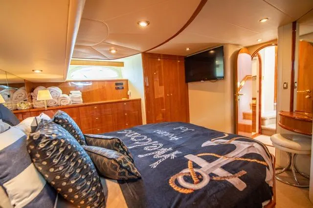 Slide: The Image of Luxurious 2005 Neptunus 62 Flybridge yacht bedroom with nautical decor and modern amenities. - 31