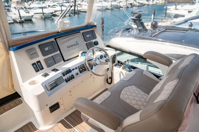 Slide: The Image of 2005 Neptunus 62 Flybridge helm with Garmin navigation, overlooking marina. - 40