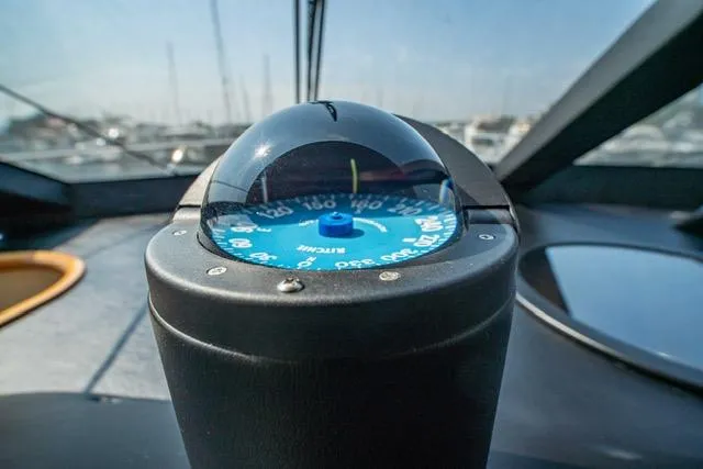Slide: The Image of Compass on 2005 Neptunus 62 Flybridge yacht dashboard. - 41