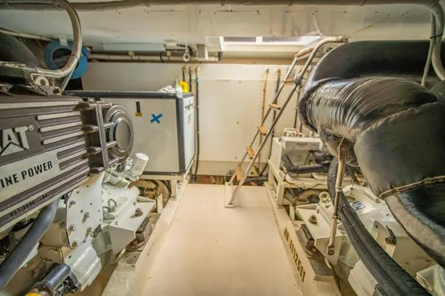 Slide: The Image of Engine room of 2005 Neptunus 62 Flybridge yacht, featuring CAT marine power. - 44