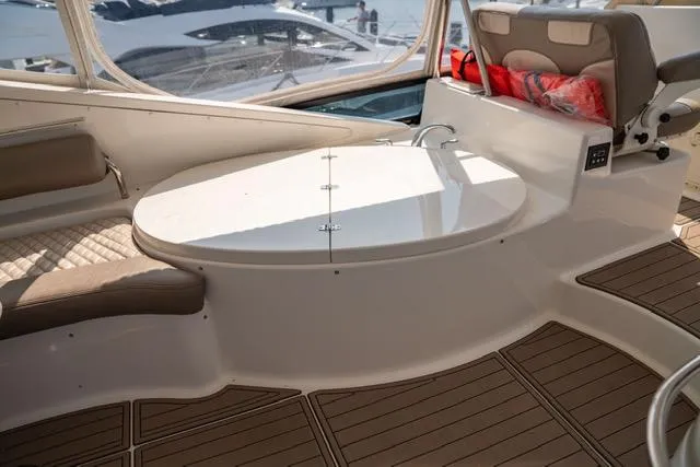 Slide: The Image of Luxurious 2005 Neptunus 62 Flybridge yacht interior with elegant seating and table. - 46
