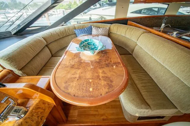 Slide: The Image of Luxurious 2005 Neptunus 62 Flybridge yacht interior with elegant wood table and plush seating. - 48