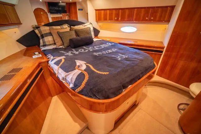 Slide: The Image of Luxurious bedroom interior of 2005 Neptunus 62 Flybridge yacht with elegant wood finish. - 49