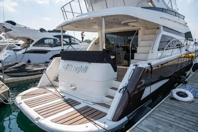 Slide: The Image of 2005 Neptunus 62 Flybridge yacht docked at marina, rear view. - 5