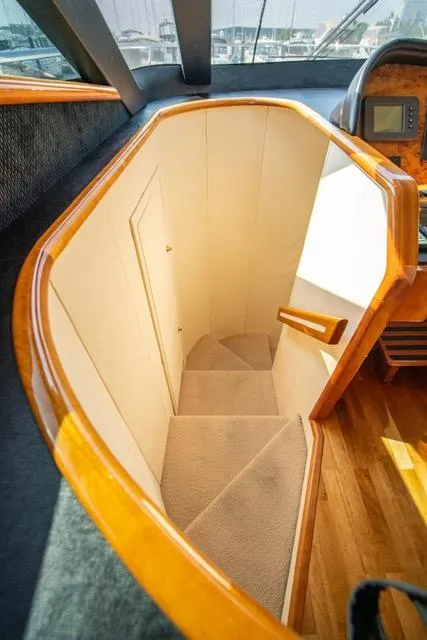 Slide: The Image of Staircase in 2005 Neptunus 62 Flybridge yacht with wooden accents and carpeted steps. - 9