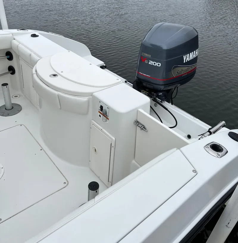 Slide: The Image of 2004 Seaswirl Striper 2301 Center Console with Yamaha V200 outboard motor on calm water. - 2