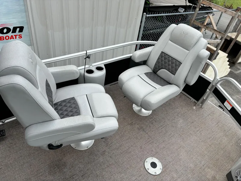 Slide: The Image of 2021 Ranger 223FC boat with two gray cushioned seats on deck. - 2