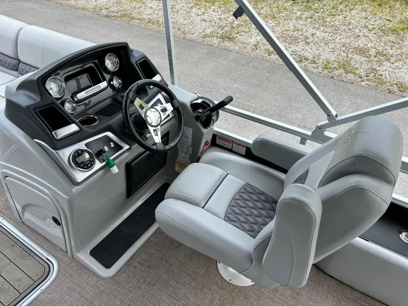 Slide: The Image of 2021 Ranger 223FC boat interior with steering wheel and captain's chair. - 4