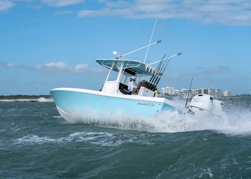 Slide: The Image of 2025 Bluewater 25 T boat navigating ocean waves under clear blue sky. - 2