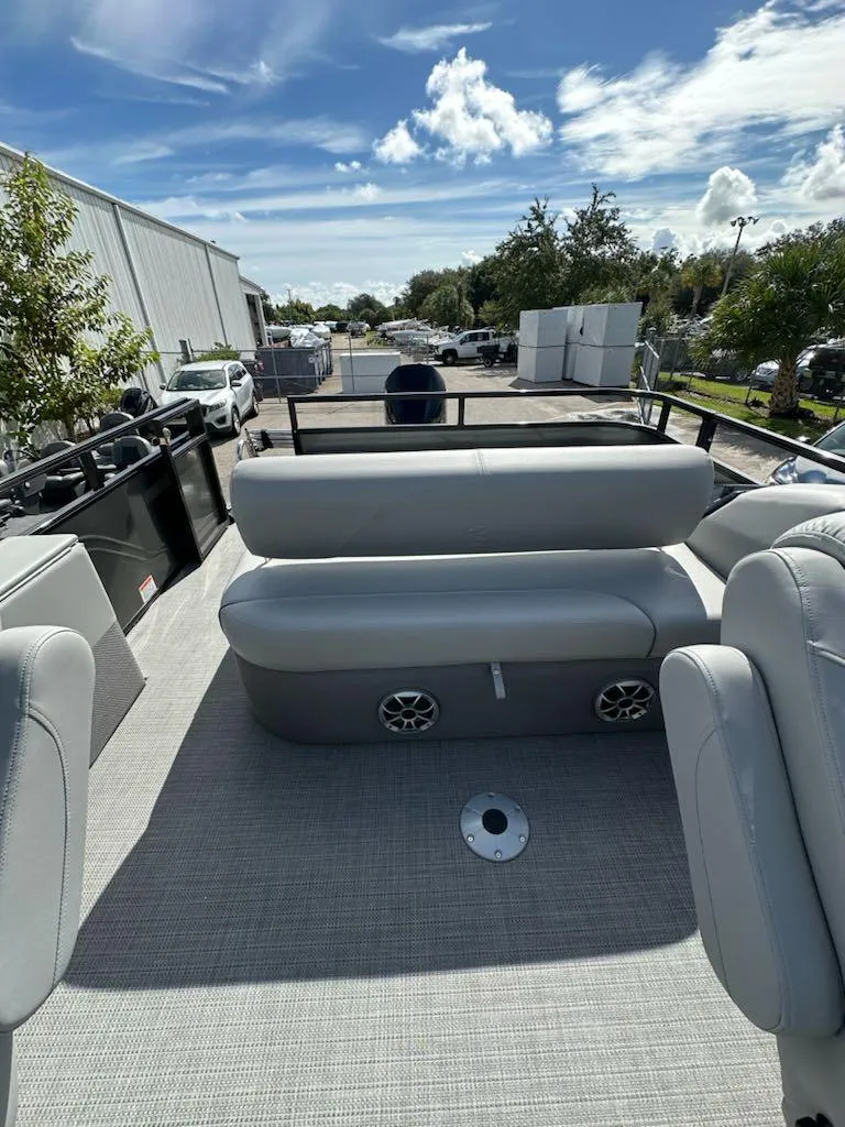 Slide: The Image of 2024 Regency 250 DL3 pontoon boat with spacious seating and modern design. - 6
