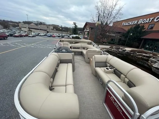 Slide: The Image of 2024 Sun Tracker Party Barge 20 DLX pontoon boat with spacious seating at a dealership. - 2