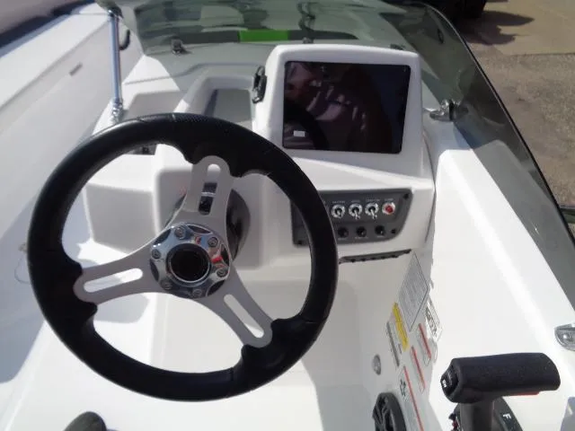 Slide: The Image of 2024 Tahoe T18 boat dashboard with steering wheel and control panel. - 13