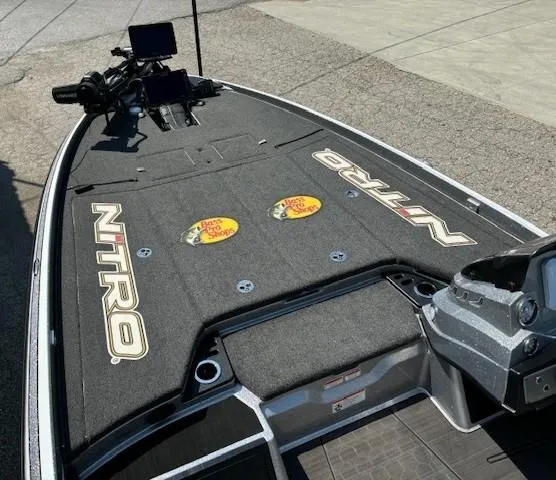 Slide: The Image of 2023 Nitro Z21 XL boat deck with fishing equipment and Bass Pro Shops logos. - 10