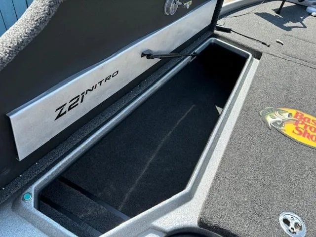 Slide: The Image of 2023 Nitro Z21 XL boat storage compartment with Bass Pro Shops logo. - 12