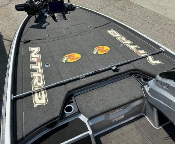 Slide: The Image of 2023 Nitro Z21 XL boat deck with Bass Pro Shops logos and fishing rod holder. - 21