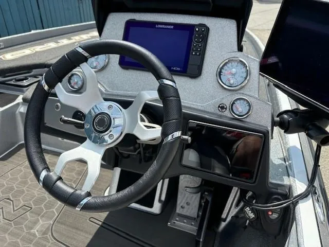 Slide: The Image of 2023 Nitro Z21 XL boat dashboard with steering wheel and electronic display. - 32