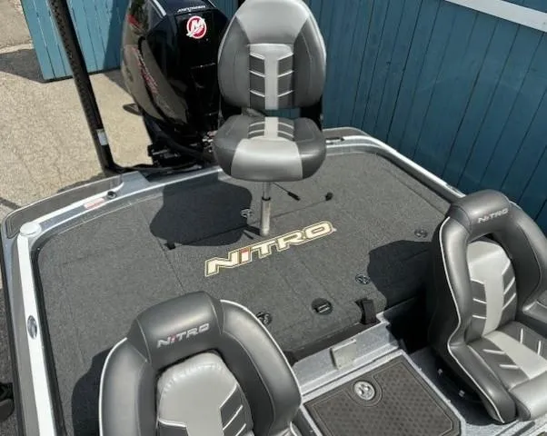 Slide: The Image of 2023 Nitro Z21 XL boat interior with three gray seats and branded flooring. - 37