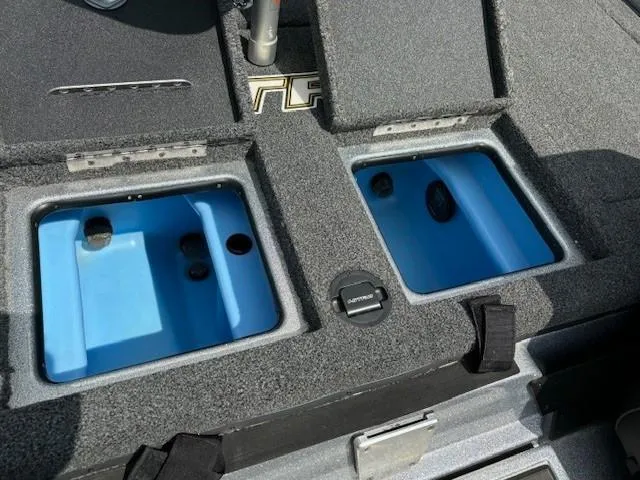 Slide: The Image of 2023 Nitro Z21 XL boat storage compartments with blue interior. - 38