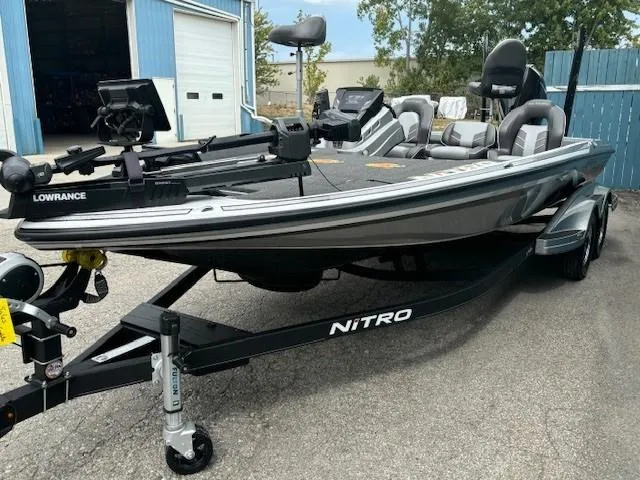 Slide: The Image of 2023 Nitro Z21 XL bass boat with trailer, parked outdoors. - 4