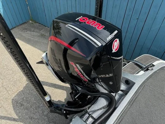 Slide: The Image of 2023 Nitro Z21 XL boat with Mercury engine, parked near blue fence. - 43