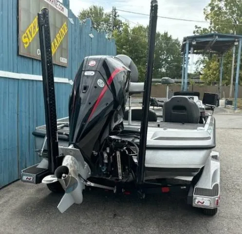 Slide: The Image of 2023 Nitro Z21 XL boat with powerful outboard motor, parked at a marina. - 6