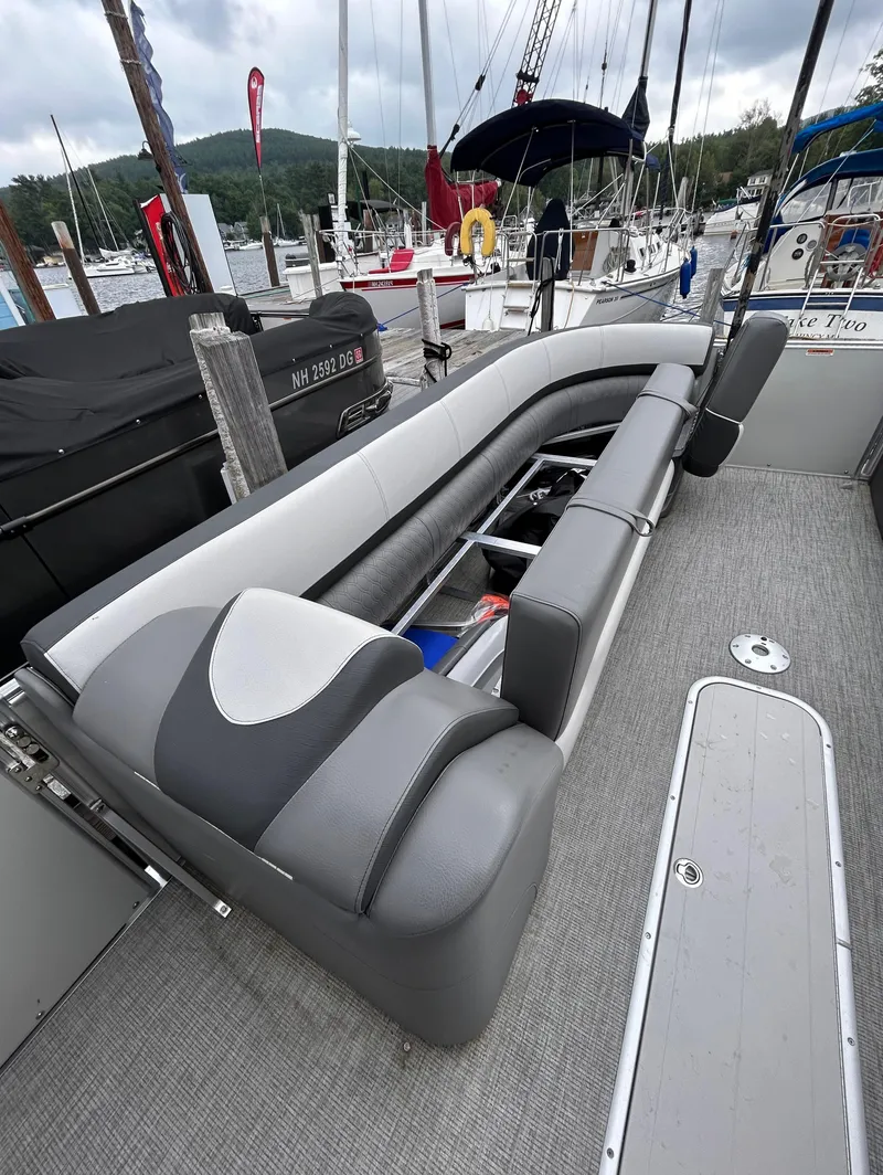 Slide: The Image of 2021 Avalon Catalina Cruise 25 boat interior with gray seating and storage compartments. - 10