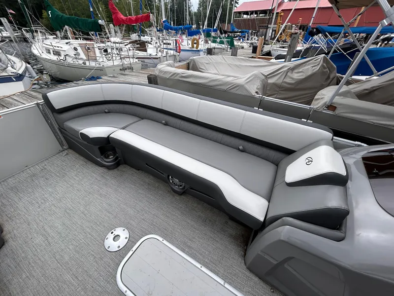 Slide: The Image of Avalon Catalina Cruise 25 boat interior with gray seating, docked at marina, 2021 model. - 13