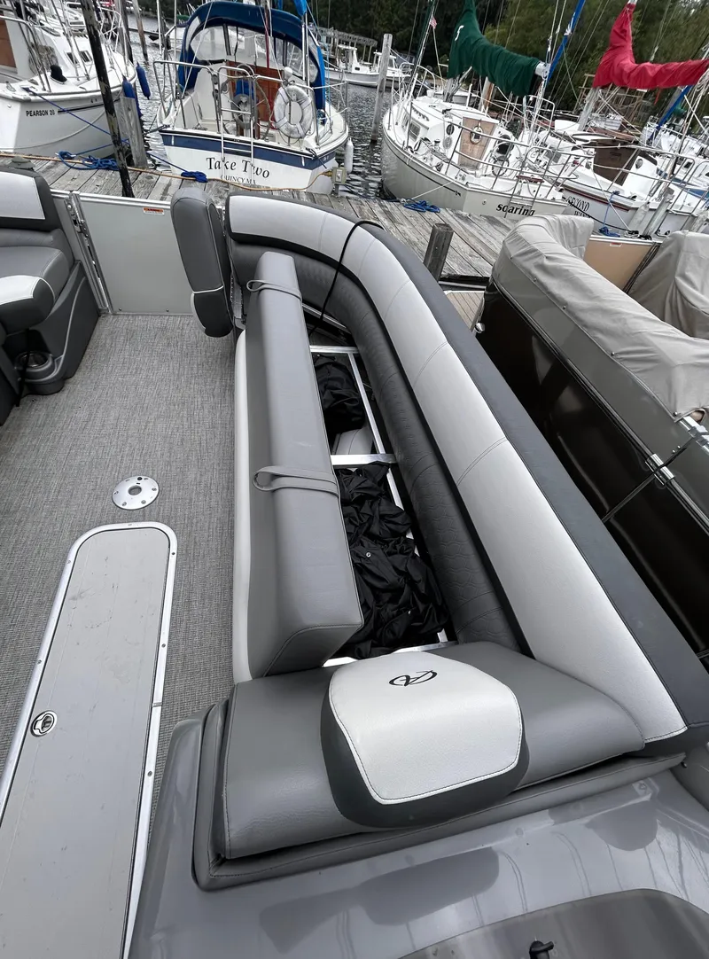 Slide: The Image of 2021 Avalon Catalina Cruise 25 pontoon boat interior with gray seating and storage. - 14
