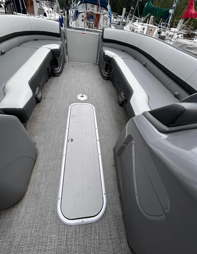 Slide: The Image of 2021 Avalon Catalina Cruise 25 interior with gray seating and carpeted floor. - 16