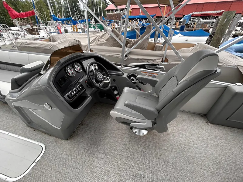 Slide: The Image of 2021 Avalon Catalina Cruise 25 boat interior with steering console and captain's chair. - 19