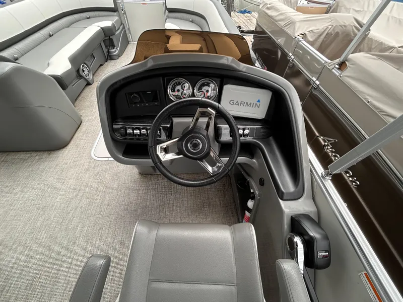 Slide: The Image of 2021 Avalon Catalina Cruise 25 boat interior with steering wheel and Garmin display. - 20
