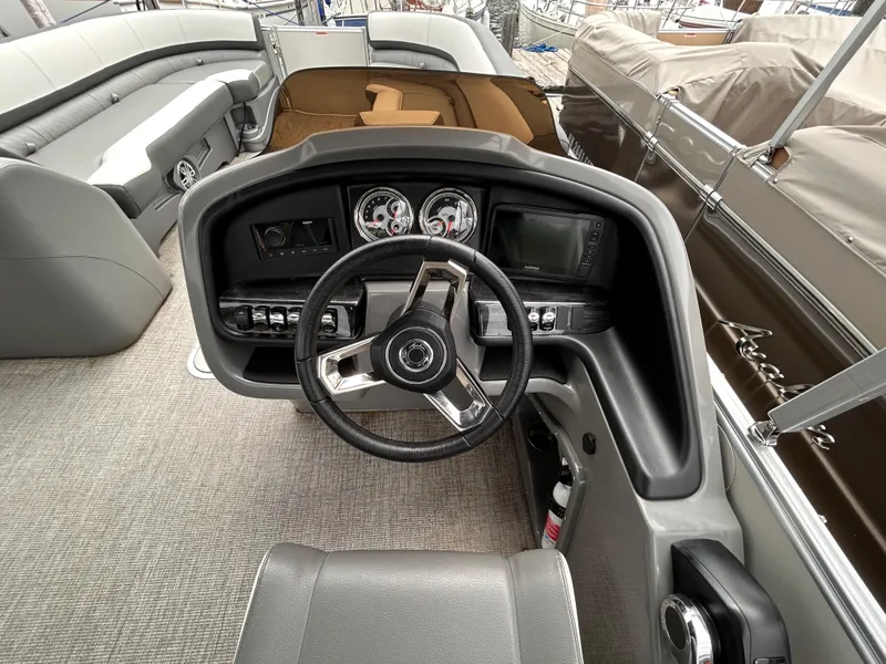 Slide: The Image of 2021 Avalon Catalina Cruise 25 boat interior with steering wheel and dashboard controls. - 21