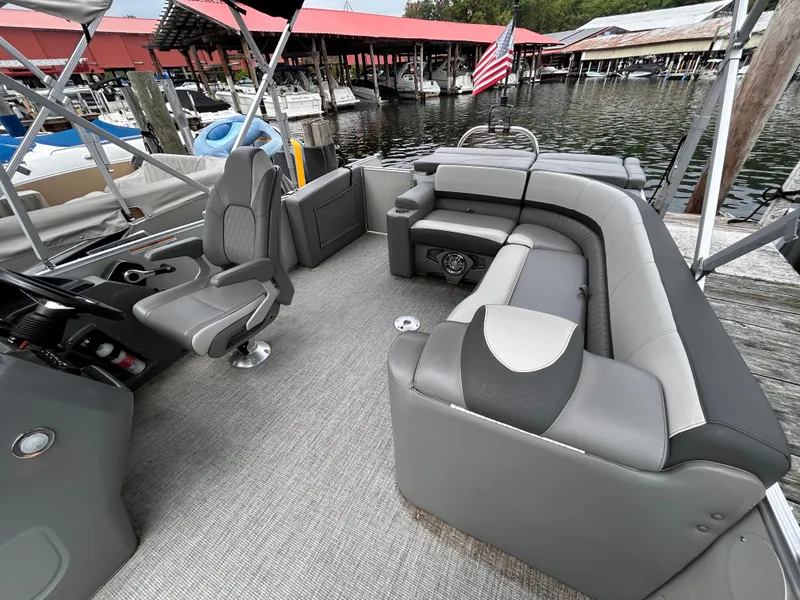 Slide: The Image of 2021 Avalon Catalina Cruise 25 pontoon boat interior with gray seating and helm. - 23