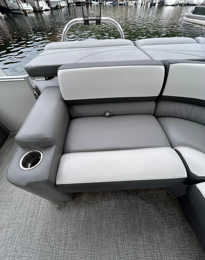 Slide: The Image of 2021 Avalon Catalina Cruise 25 boat interior with gray seating and cup holder. - 25