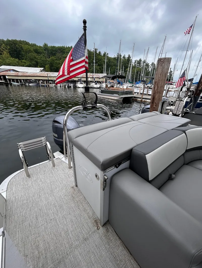 Slide: The Image of 2021 Avalon Catalina Cruise 25 boat docked at marina with American flag. - 34