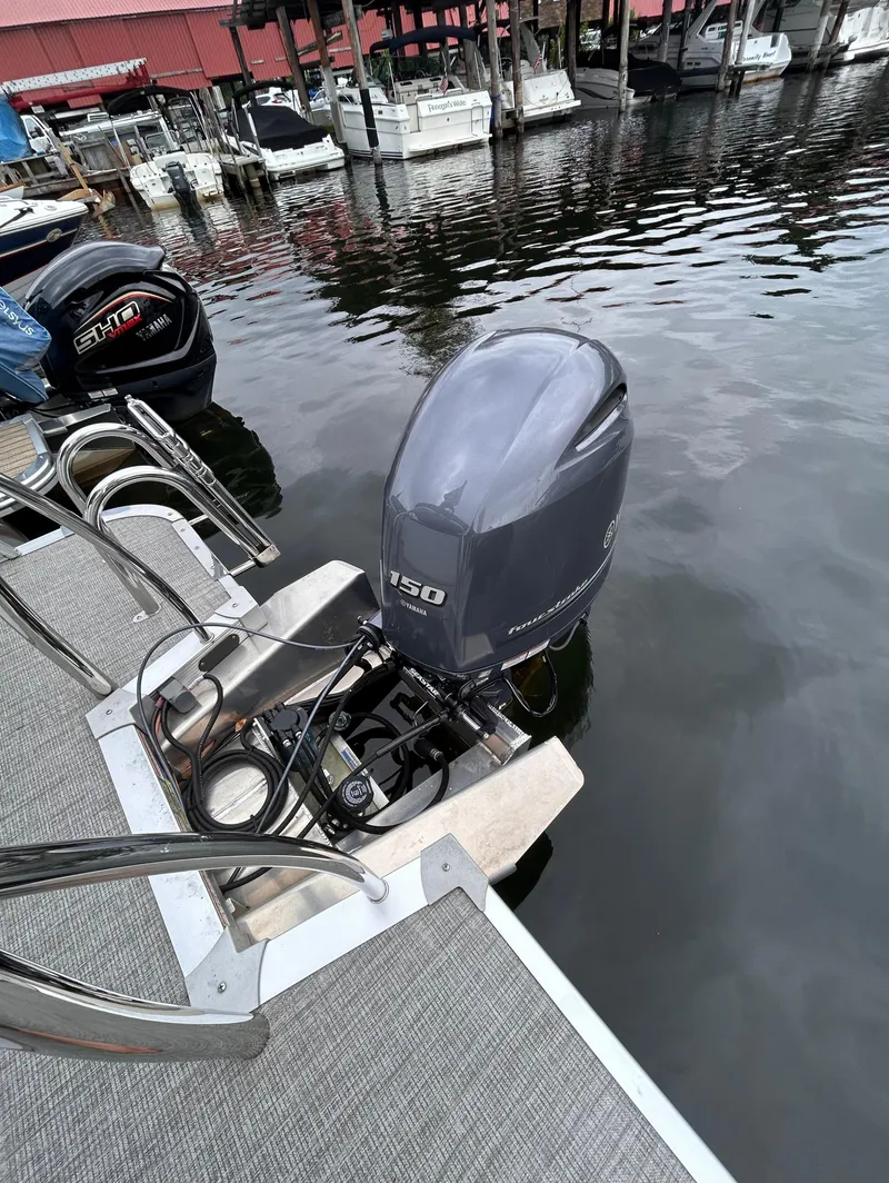Slide: The Image of Avalon Catalina Cruise 25 boat with powerful outboard motor, docked at marina, 2021 model. - 40