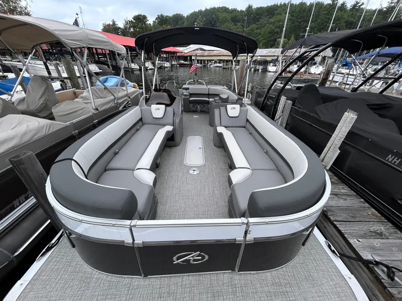 Slide: The Image of 2021 Avalon Catalina Cruise 25 pontoon boat with spacious seating at a marina. - 6