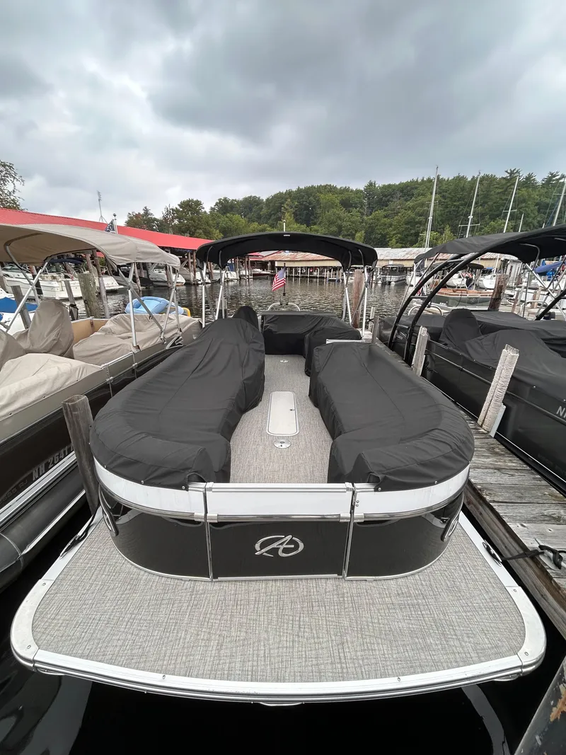Slide: The Image of 2021 Avalon Catalina Cruise 25 pontoon boat docked with cover. - 7
