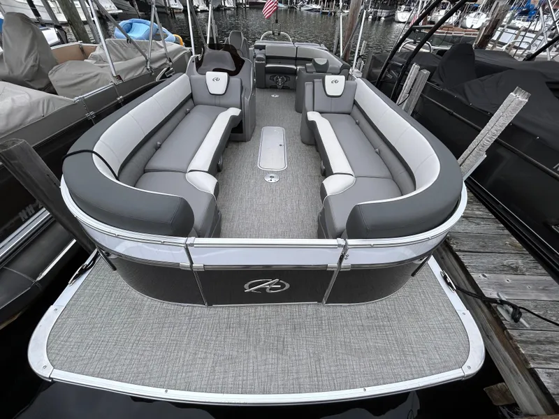 Slide: The Image of 2021 Avalon Catalina Cruise 25 pontoon boat with spacious seating at a marina. - 8