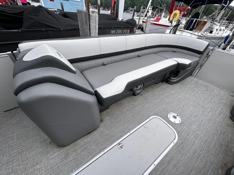 Slide: The Image of 2021 Avalon Catalina Cruise 25 boat interior with gray seating and carpeted floor. - 9