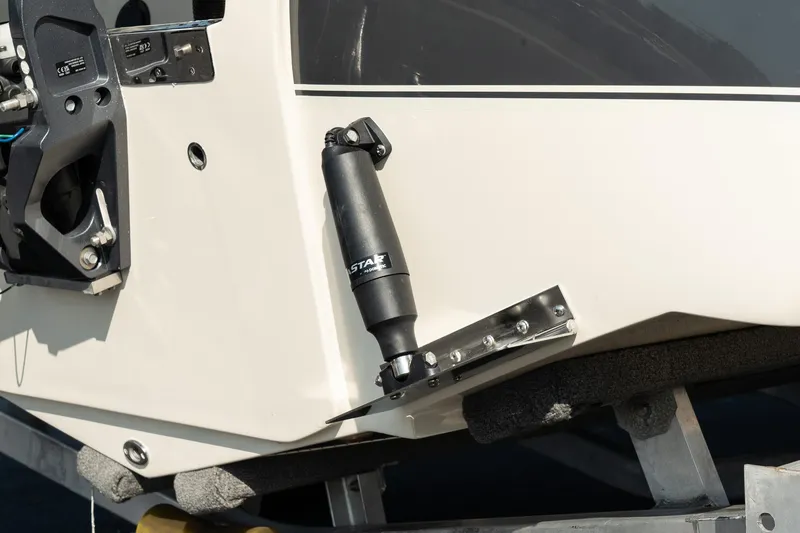 Slide: The Image of 2025 Scout 195 Sportfish boat detail with trim tab and hydraulic actuator. - 12