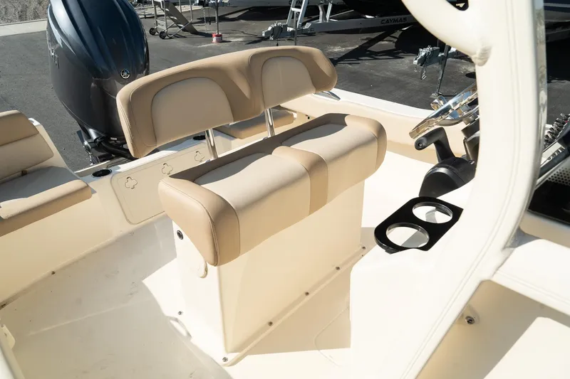 Slide: The Image of 2025 Scout 195 Sportfish boat interior with beige seating and dual cup holders. - 16
