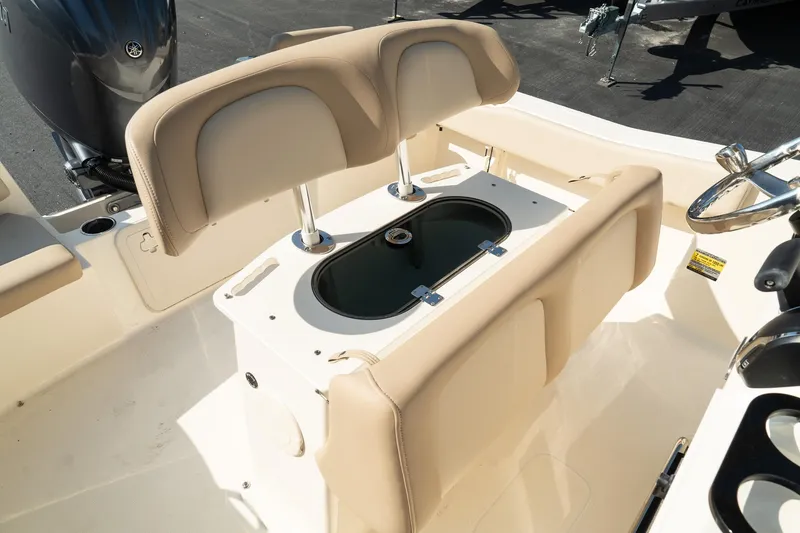 Slide: The Image of 2025 Scout 195 Sportfish boat interior with beige seating and storage compartment. - 17