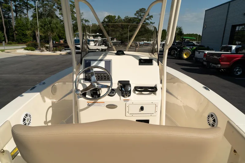 Slide: The Image of 2025 Scout 195 Sportfish boat interior with steering wheel and controls. - 18