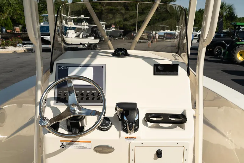 Slide: The Image of 2025 Scout 195 Sportfish boat dashboard with steering wheel and controls. - 20