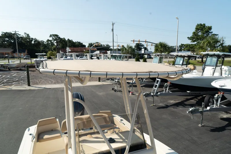 Slide: The Image of 2025 Scout 195 Sportfish boat with T-top in a marina setting. - 28