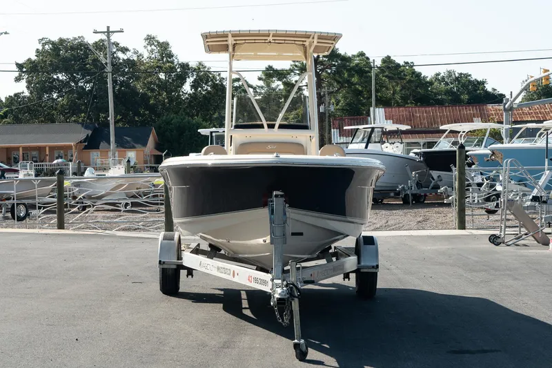 Slide: The Image of 2025 Scout 195 Sportfish boat on trailer in marina setting. - 7