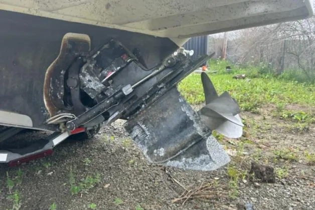 Slide: The Image of Damaged propeller of a 1997 Sea Ray 270 Sundancer on a grassy surface. - 2