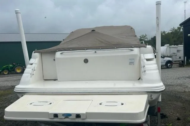 Slide: The Image of 1997 Sea Ray 270 Sundancer boat with cover, parked outdoors. - 4